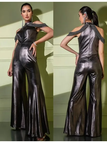 A full front and back view of the metallic gunmetal jumpsuit, showing off its dramatic flared silhouette and unique embellished harness.