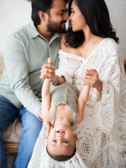 Playtime! A fun shot with the baby held upside down, bringing out the biggest giggles.