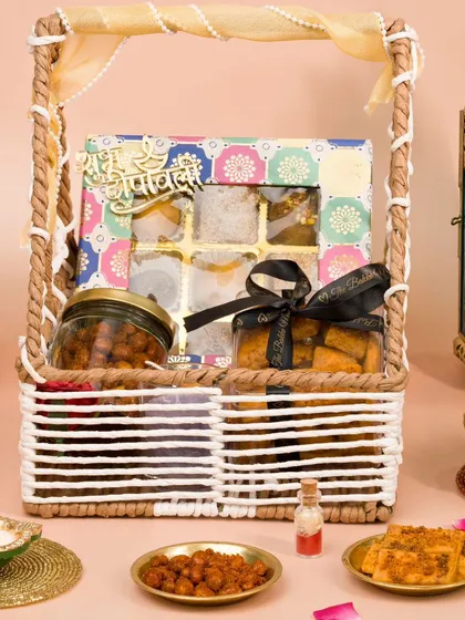 A beautifully curated Diwali hamper basket with sweets and snacks. We style hampers to look abundant and gift-worthy, making them highly desirable for festive shoppers.