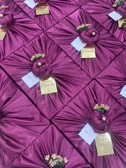 This array of beautifully wrapped gifts in rich purple satin was for a large Diwali order. Each gift is topped with a golden "Happy Diwali" tag, ready to be sent out to bring joy to many homes and offices.