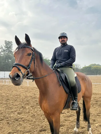 A rider and his horse, Castell Gandolfo, share a quiet moment in the training arena. We believe the partnership between horse and rider is the most important part of the sport.
