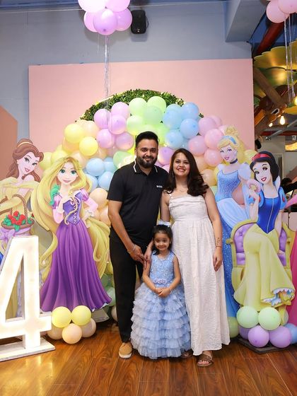 A beautiful family portrait in front of the full Disney Princess backdrop. We help you capture the perfect family photo to remember the special day.