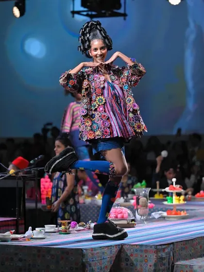 Live from Lakme Fashion Week, this look was all about playful structure. I created a towering, multi-bun sculptural hairstyle that added height and drama, perfectly matching the whimsical and colorful aesthetic of the designer's collection.