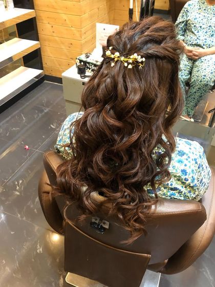 Another angle of the romantic half-updo, showing the detail of the twist and the placement of the accessory.