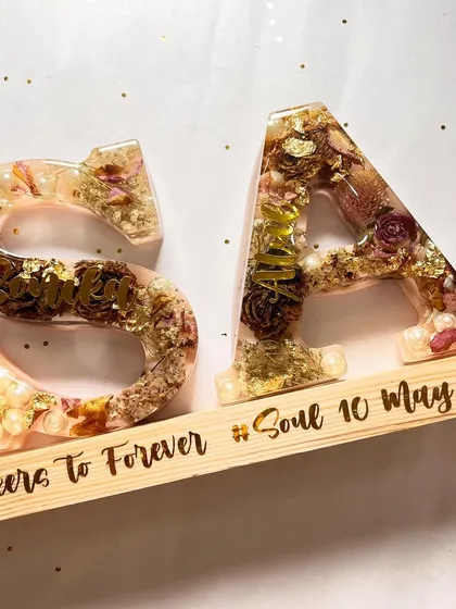The same 5.5-inch alphabet lamp with the lights off, showing the natural beauty of the preserved flowers and the custom engraving on the wooden base.
