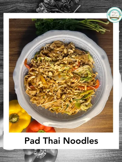 My Pad Thai Noodles are a stir-fry of flat rice noodles with vegetables, tofu, and a sweet and sour sauce, topped with crushed peanuts. It's a classic Thai street food dish, made completely vegetarian.