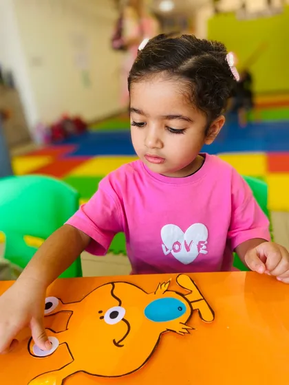 A young girl works on her own unique alien creation. We encourage individuality and personal expression in all our art projects.