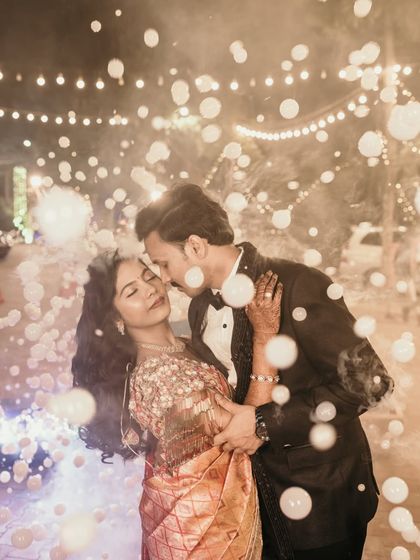 A romantic reception photo with the couple dancing under a shower of bubbles.