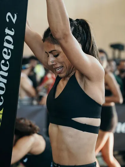The face of pure effort on the Concept2 rower during a competition. Rowing is a full-body workout that builds a massive aerobic engine, a cornerstone of my endurance programming.