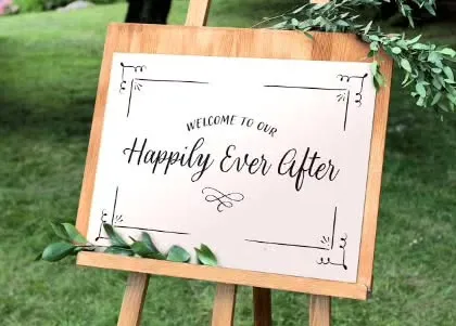 A simple and charming wooden welcome sign with elegant calligraphy. It's a lovely way to greet guests and set the tone for a rustic or classic wedding.