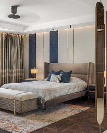 A master bedroom featuring a custom room divider made of rotating brass-edged panels. This element adds a dynamic architectural feature while separating the sleeping area from the walk-in closet.