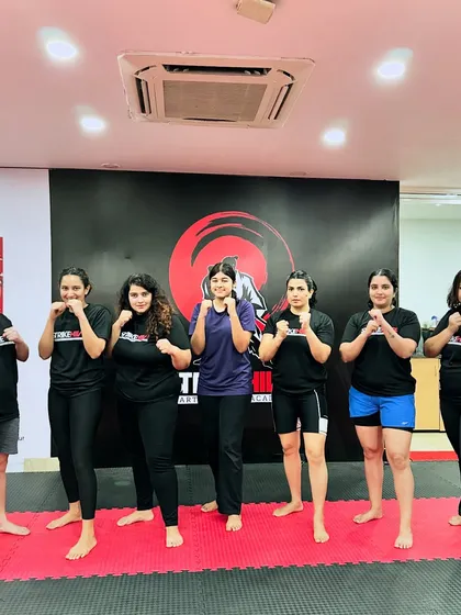 A group of women from our academy stands together in a fighting stance. This image captures the strength, solidarity, and spirit of the female members of the StrikeHive community.