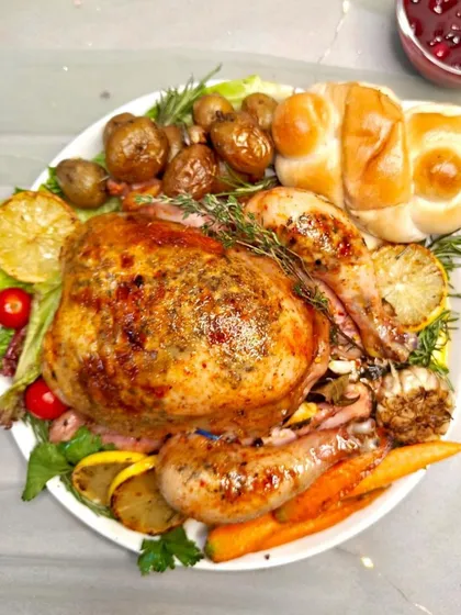 Hop into spring with our Easter feast! This image showcases a succulent whole roasted chicken, stuffed and glazed to perfection, ready to be the centerpiece of your celebration.