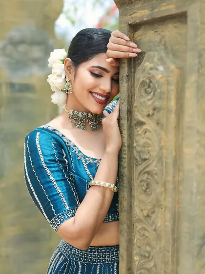 This look is all about soft glam. I focused on creating a smooth, glowing base and defined eyes that complement this stunning blue lehenga, making my client feel confident and beautiful for her shoot.