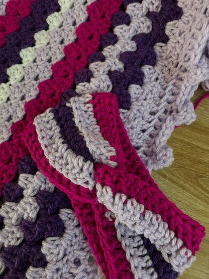 A close up detail of the striped blanket, showing the neatness of the stitches and the beautiful blend of colors. We also made a matching headband to go with this piece.