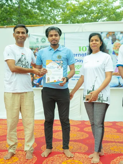 Receiving a certificate of appreciation for conducting the yoga session on International Day of Yoga.
