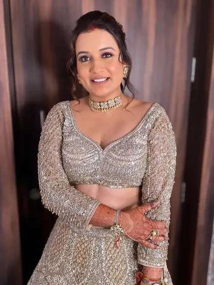 The full look, showcasing the sparkling lehenga and the complementary glamorous makeup.