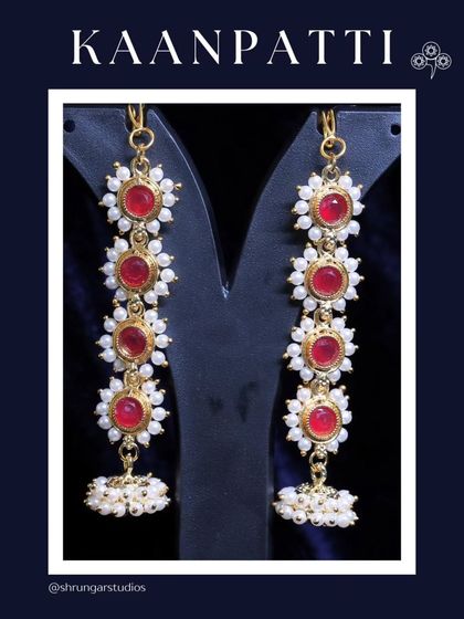 A beautiful floral design Kaanpatti with red stones and pearls.