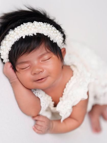 A sweet, sleepy smile that just melts your heart. Capturing these moments is what makes my job so rewarding.