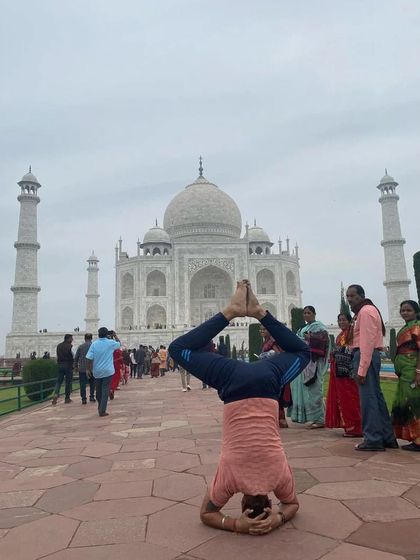 Another headstand variation in front of the Taj Mahal. This one with bent knees challenges the balance in a different way.