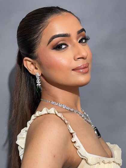 A close-up of the final look, showcasing the glossy lip and the flawless base.