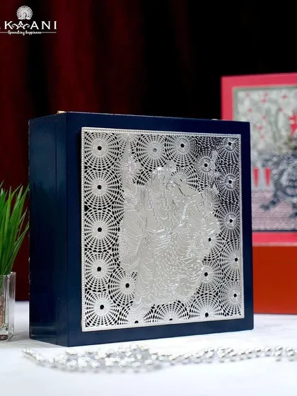 The perfect blend of luxury and artistry. This stunning navy blue gift box features a silver-plated Radha Krishna design, ideal for those who appreciate the finer things in life.