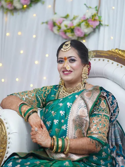 The bride-to-be looking serene and happy. The makeup is soft and luminous, perfect for an intimate engagement function.