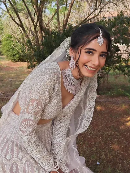 The pure joy on my bride's face says it all. For her modern white-themed wedding, I created a soft and romantic makeup look with a messy bun that felt both effortless and elegant.