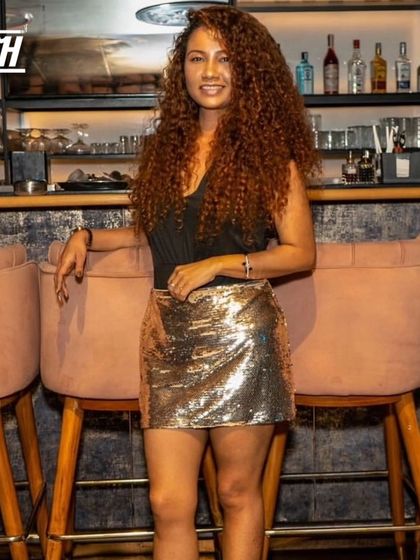 A confident and stylish partygoer posing by the bar at Babylonia.