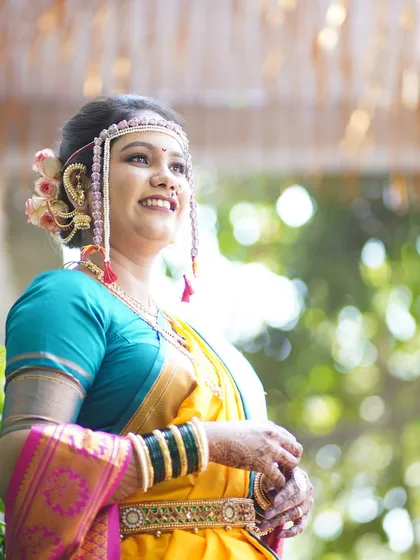 A candid shot of the bride looking up, filled with hope and happiness. The natural lighting enhances the glow of her skin.