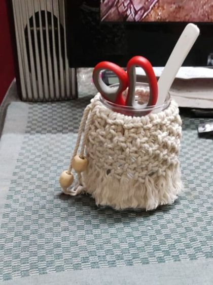 A student's work, this macrame utility jar is being used as a stationery holder. It's a perfect example of how you can create functional art for your home.