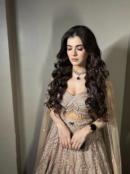 A moment of quiet beauty before the celebrations begin. The soft, shimmery eye makeup looks just as stunning with her eyes closed.