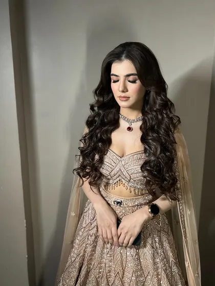 A beautiful shot with her eyes closed, showing the soft, blended eyeshadow that complements her grand outfit.