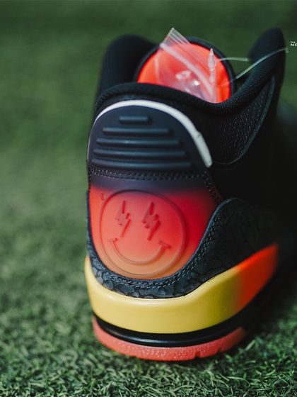 Detail of the translucent heel tab on the Jordan 3 J Balvin 'Rio', showing the lightning-eyed smiley face logo.