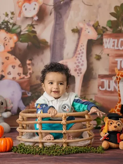 Welcome to the jungle! This is an example of a fun, themed studio session for a baby, complete with a custom backdrop and adorable animal props.