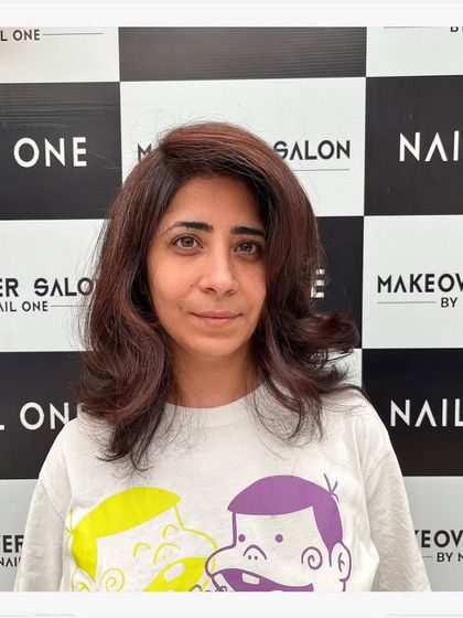 The client looking happy and confident with her fresh haircut and color. Her hair looks healthy, voluminous, and perfectly styled.