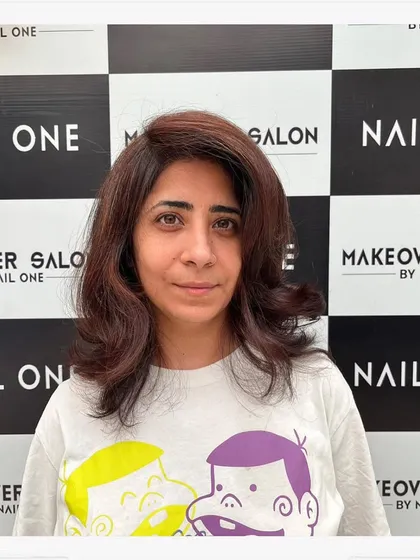 The client looking happy and confident with her fresh haircut and color. Her hair looks healthy, voluminous, and perfectly styled.