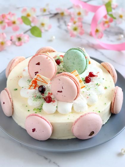 Our Valley of Vanilla Cake is a slice of heaven. Layers of soft vanilla sponge and fruit of the forest jelly are covered in silky cream and garnished with delicate macarons.