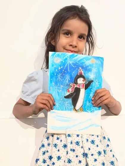 This young artist is very happy with her soft pastel penguin, complete with falling snowflakes.
