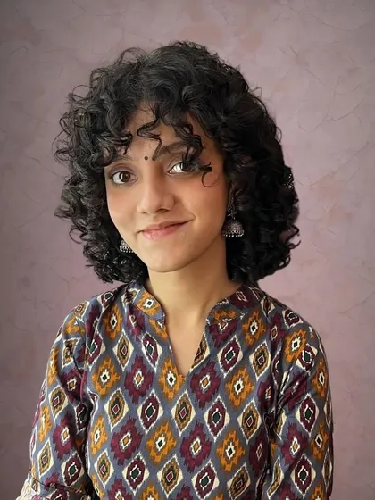 A successful curly cut is all about the shape and definition. Here, I gave my client Vageesha a full curl transformation with bangs, creating a style that enhances her natural texture.