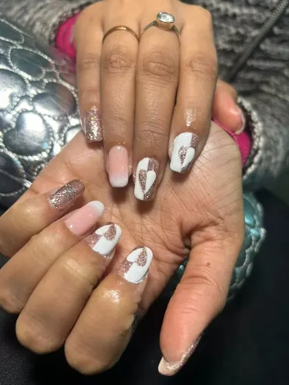 A close-up of this romantic nail art set. I used a combination of baby boomer ombre, rose gold glitter, and a unique split-heart design in white and glitter for a truly special look.
