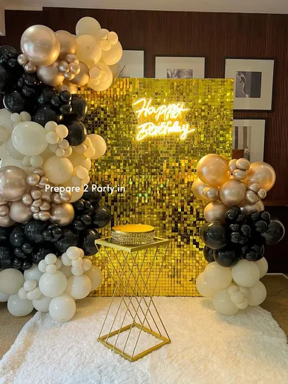 This full view showcases how our gold sequin backdrop, balloon columns, and cake stand come together to create a complete and cohesive focal point for a birthday party.