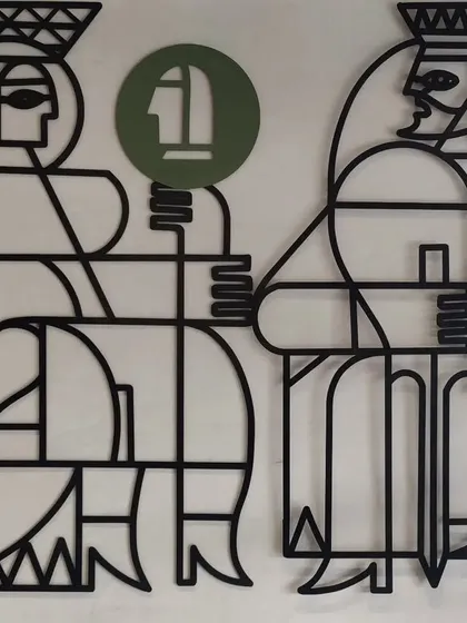 A detail of the Queen and King figures, crafted from laser-cut metal.