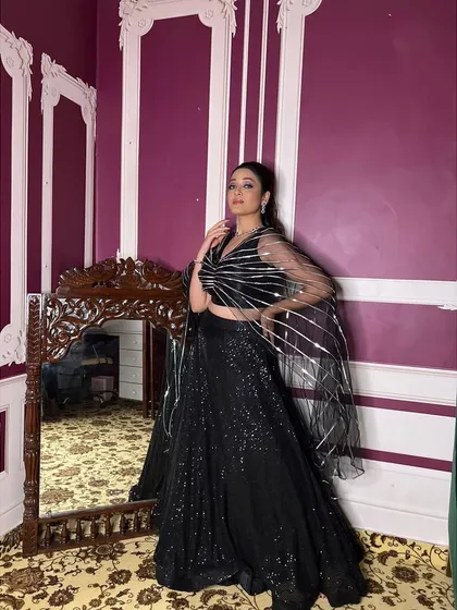 A full look at the black sequin lehenga, reflecting the light beautifully. This is the perfect outfit to rent when you want to shine and make a bold statement.