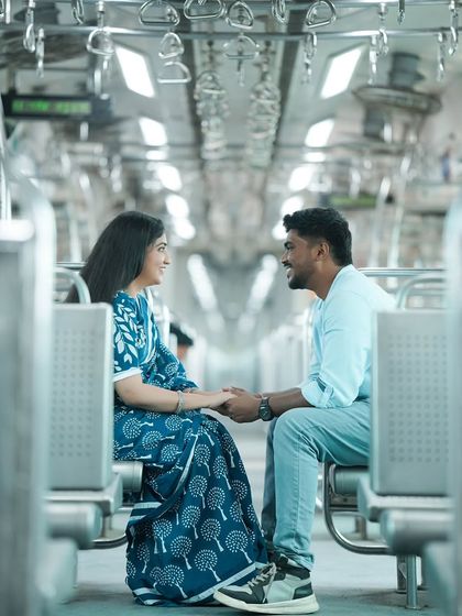 I love the symmetry of the train car in this shot, which frames the couple perfectly. Their interaction feels natural and happy, making this a great candid moment from our Mumbai local train pre-wedding shoot.