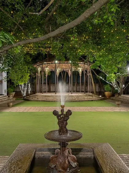 At night, the bandstand and lawn are lit by strings of fairy lights, creating a magical, starlit canopy for your celebrations.
