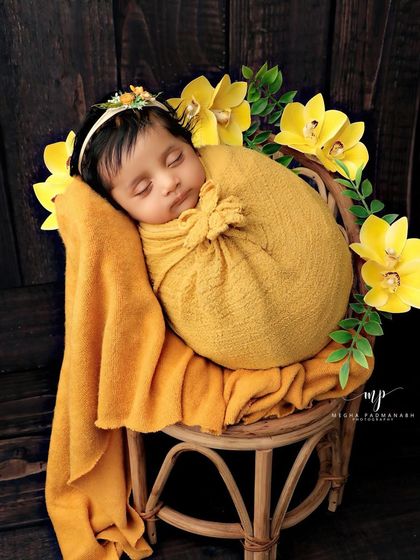 The baby is back to sleep, looking peaceful and content in the yellow-themed setup.