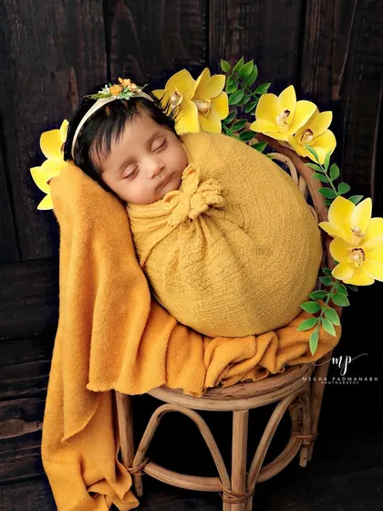 The baby is back to sleep, looking peaceful and content in the yellow-themed setup.