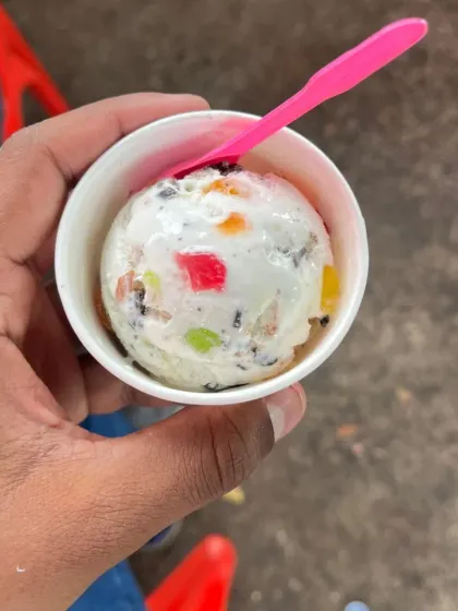 A cup of tutti frutti ice cream, a fun and colourful dessert option, especially for birthdays and family gatherings.