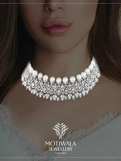 A cascade of brilliance for the modern sophisticate. This diamond and pearl choker necklace offers a contemporary take on classic elegance, featuring rows of lustrous pearls framed by intricate diamond work. It is designed to sit gracefully on the collarbone, making it a perfect statement for evening wear.